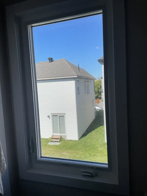 Clear bathroom window with a full view of the neighbour's house, Ottawa