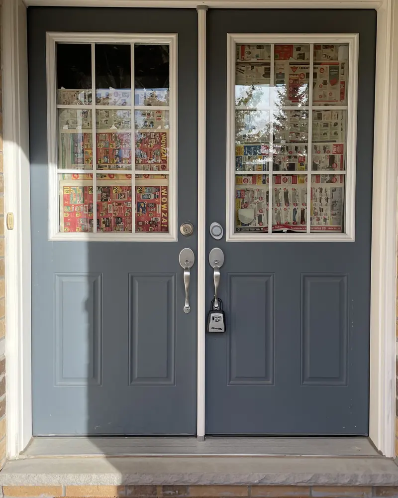 Broken double door glass papered over before replacement, Ottawa