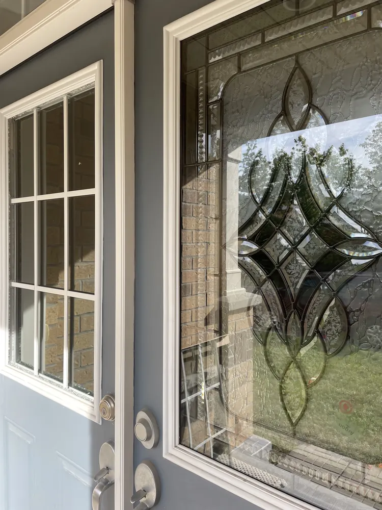 Old clear door glass on the left beside new tempered glass on the right, Ottawa