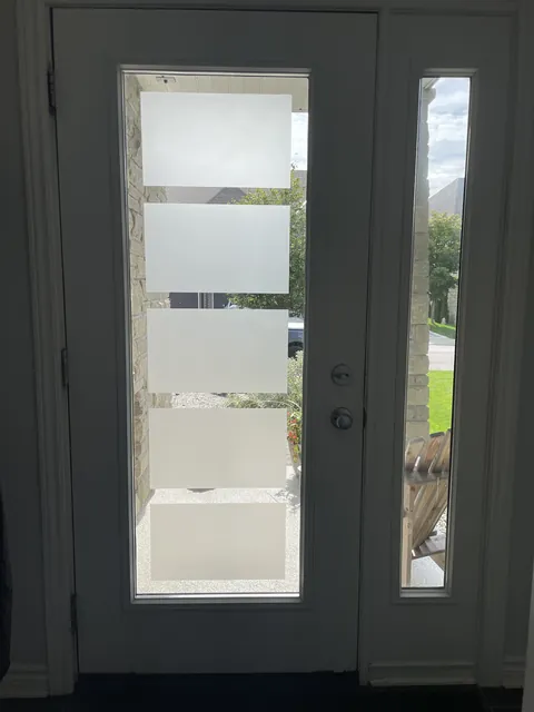 Privacy film strips stuck on front door glass, Ottawa