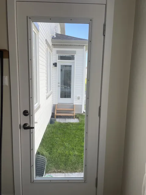 Before: clear back door glass looking straight at the neighbour’s door